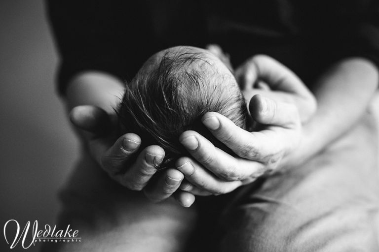 newborn daughter in daddys hands