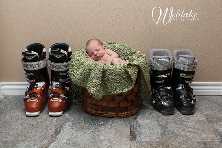 newborn baby with ski boots