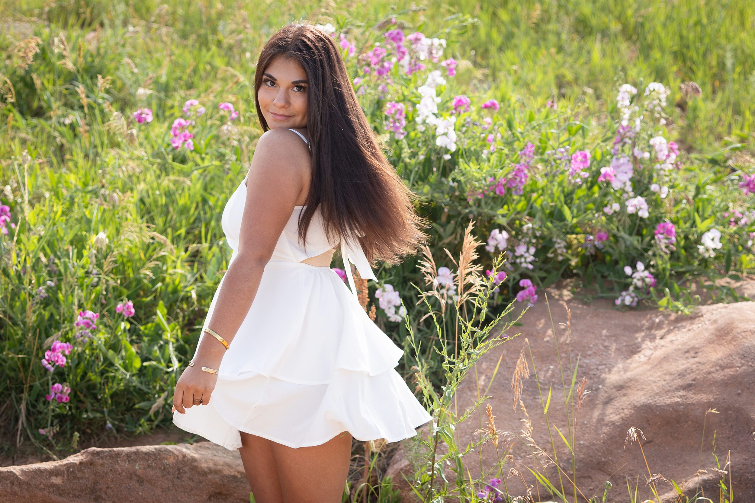 Senior picture in a meadow of wildflowers